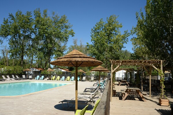 Seasonal outdoor pool, open 10:00 AM to 7:00 PM, pool umbrellas