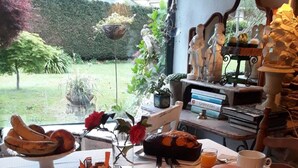 A breakfast table set with bread, a teapot, and a cup of tea. - A Cortiña de Canalarrana (Ribadeo)