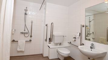 A modern bathroom with a shower, toilet, and sink.