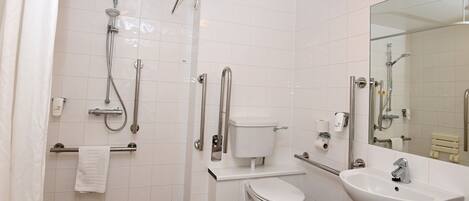 A modern bathroom with a shower, toilet, and sink.