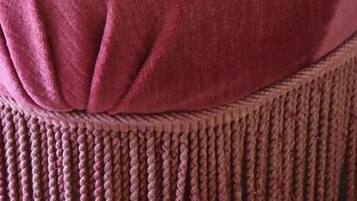 A close-up of a chair with a high back and a cushioned seat.