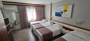 Quarto quádruplo standard, várias camas | Frigobar, cofres nos quartos, escrivaninha, cortinas blackout