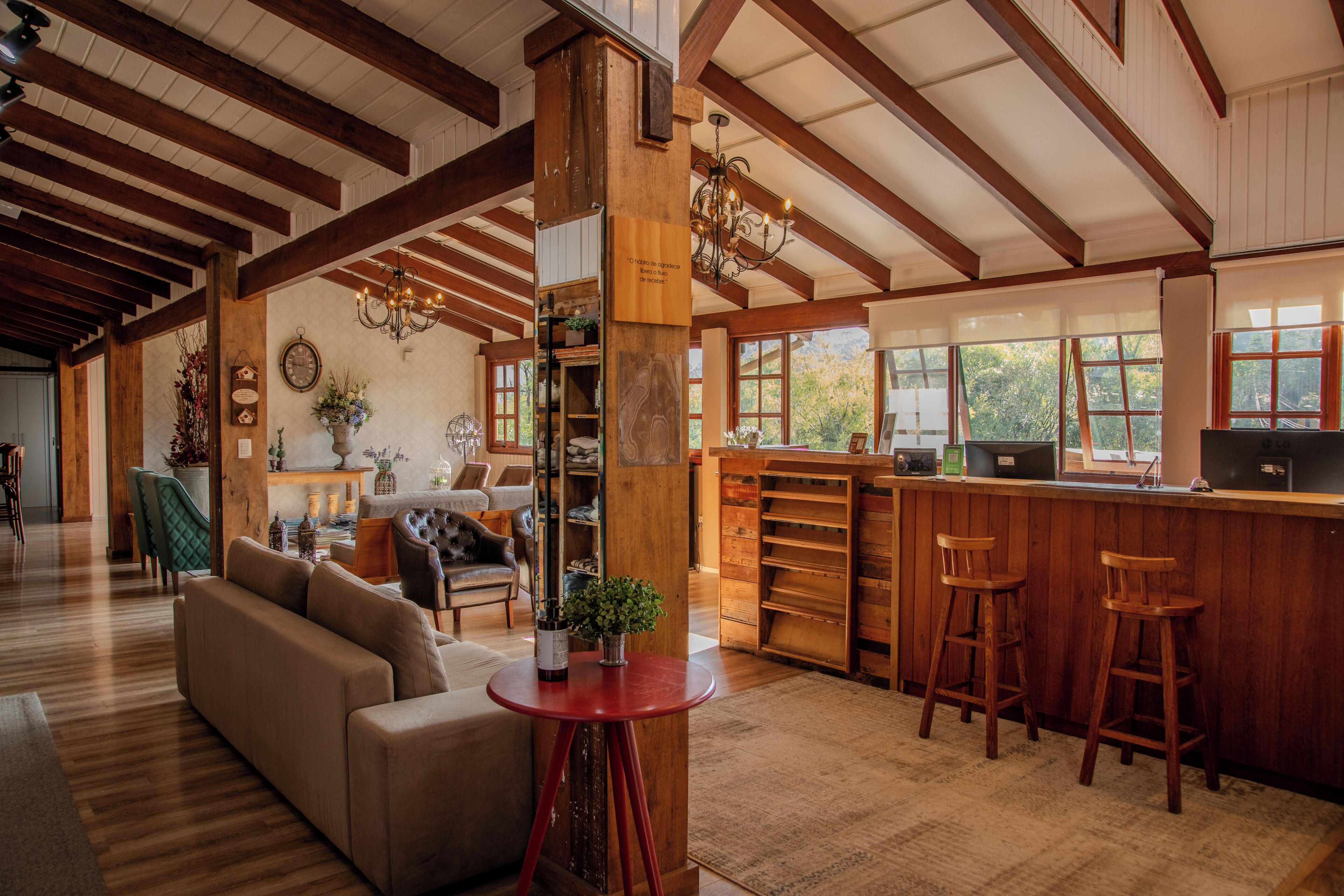 A spacious interior with a wooden ceiling, a bar area, and seating.