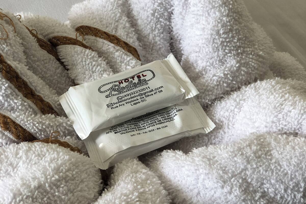 A white, fluffy towel with a small white tag attached to it.