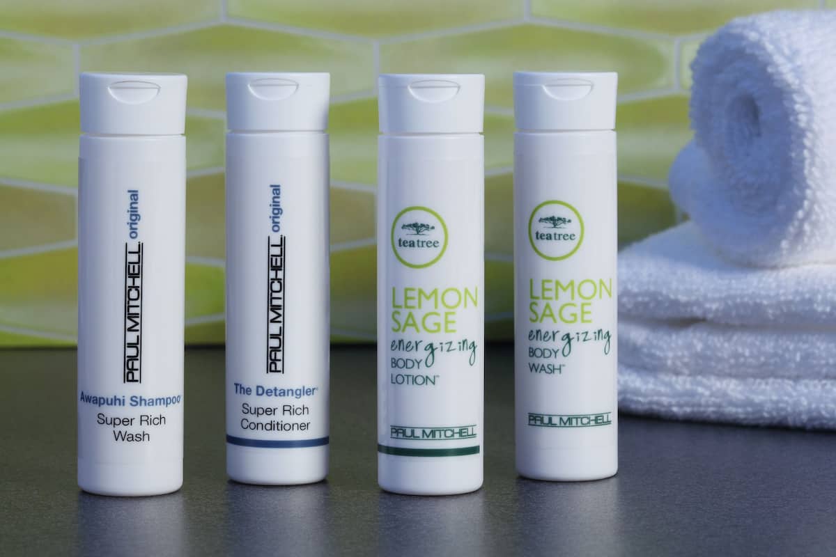 designer toiletries, hair dryer, towels