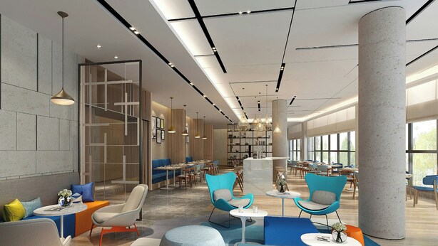 A modern interior with seating areas, a large pillar, and a visible staircase.