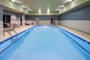 A swimming pool with a blue tiled edge, a lifeguard chair, and a door to the changing rooms. - Holiday Inn Express & Suites Lexington W - Versailles by IHG (Versailles)