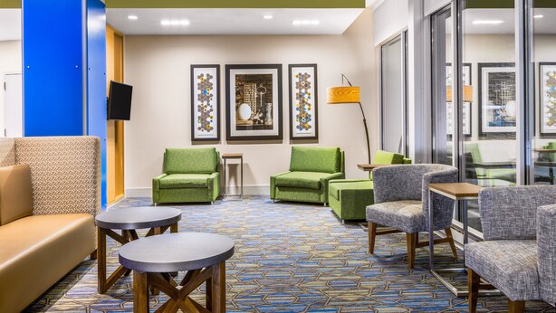 A lobby with seating arrangements, a patterned carpet, and framed artwork on the wall. - Holiday Inn Express and Suites Union Gap- Yakima Area by IHG (Yakima)