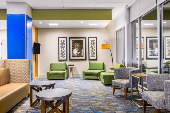A lobby with seating arrangements, a patterned carpet, and framed artwork on the wall. - Holiday Inn Express and Suites Union Gap- Yakima Area by IHG (Yakima)