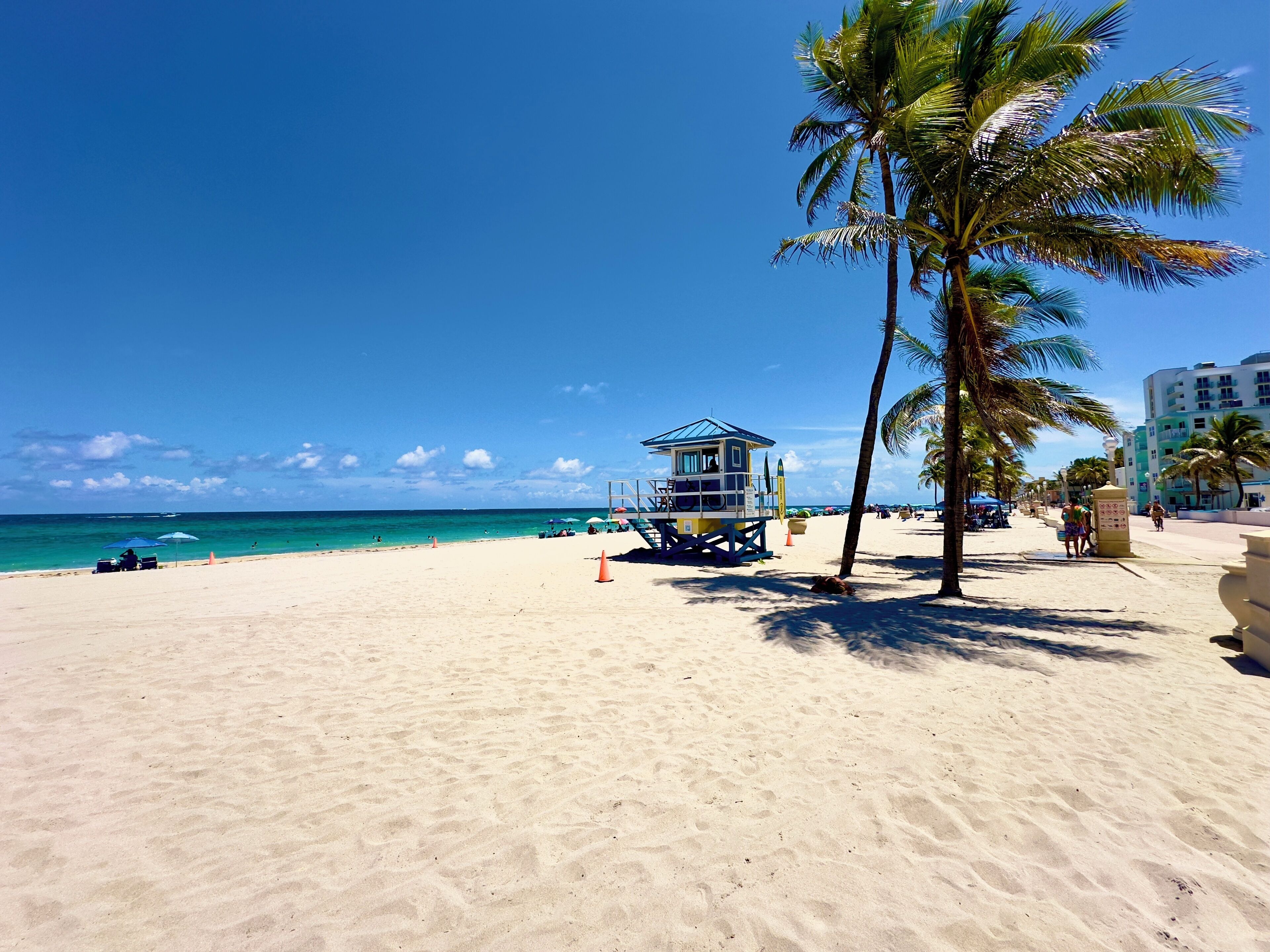 On the beach, white sand, beach umbrellas, beach towels