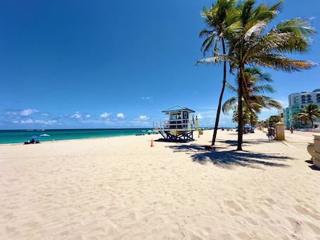 On the beach, white sand, beach umbrellas, beach towels