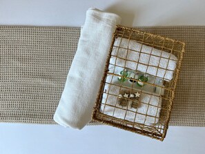A bed with a white pillow and a decorative headboard with a woven frame. - Hygge Ayvalık (Ayvalik)