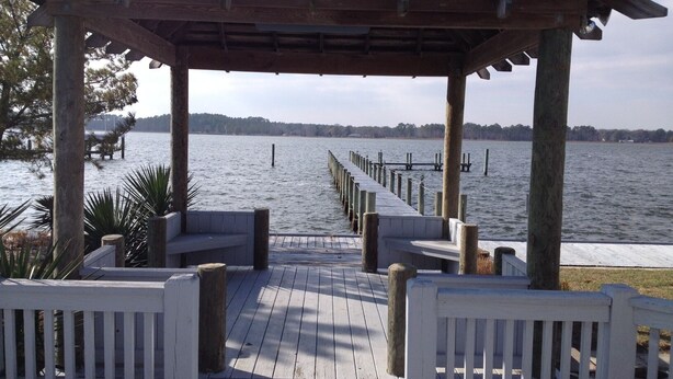A wooden gazebo with benches overlooking a lake. - Quiet Waterfront House Sleeps10, Plenty Of Parking, Boat Slip (Rehoboth Beach)