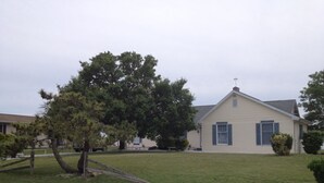 A single-story house with a sloped roof and a small front porch. - Quiet Waterfront House Sleeps10, Plenty Of Parking, Boat Slip (Rehoboth Beach)