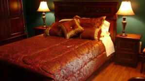 A bed with a patterned bedspread, two bedside lamps, and a wooden headboard. - Room #6 We are only 30 min. away from  "BASEBALL HALL OF FAME" in Coopers Town . (Fort Plain)