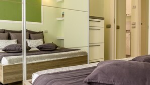 A bedroom with a bed, a wardrobe, and a mirror. - Casa Failla Taormina center (Taormina)