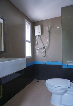 A bathroom with a bathtub, toilet, and a shower.
