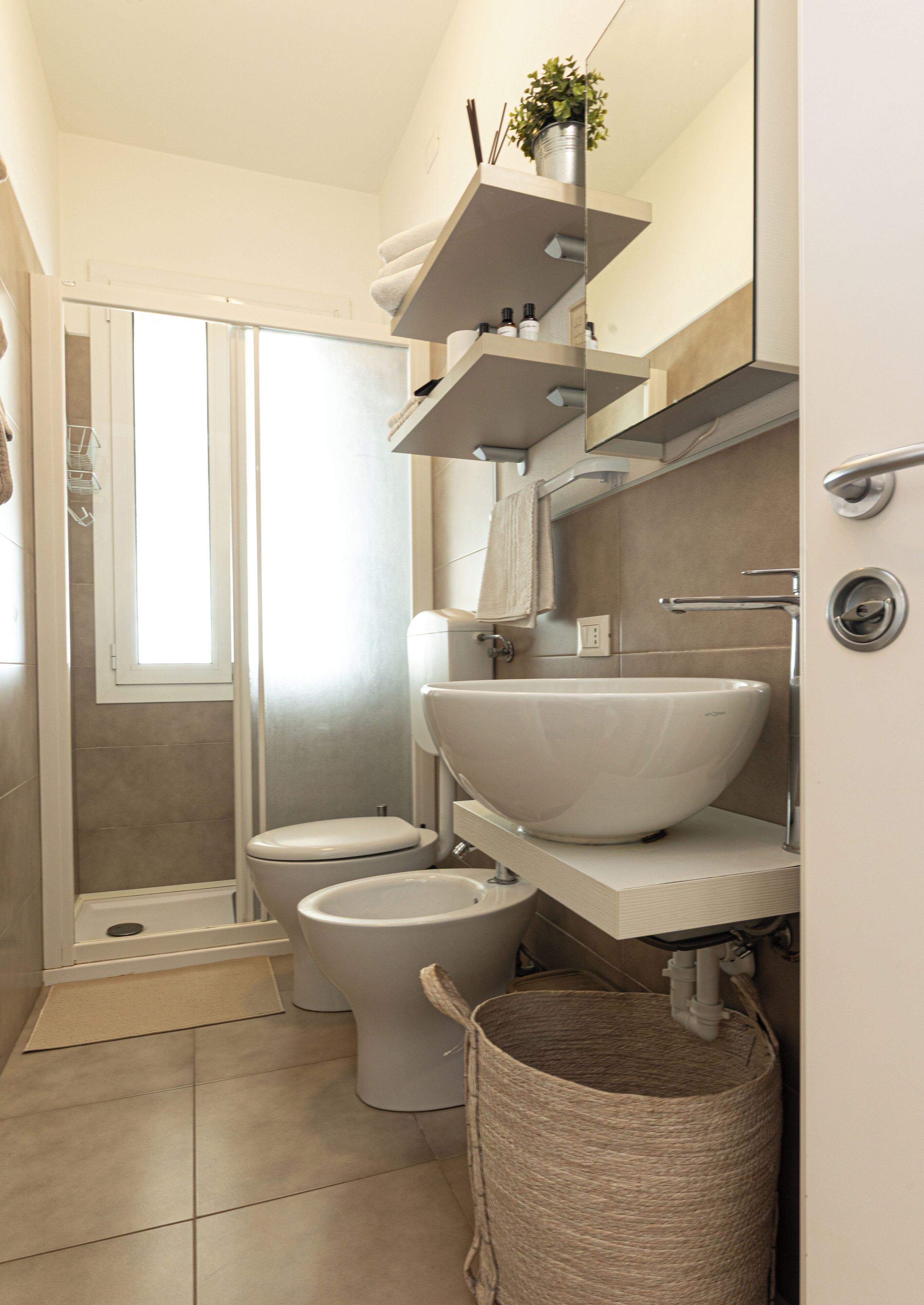 A bathroom with a shower, toilet, and sink.