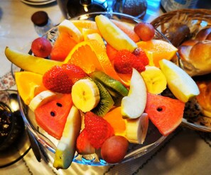 A fruit platter with various fruits including strawberries, bananas, and watermelon. - Double room 1 incl. extended breakfast (room no. 4) - Weindlhof (Waidring)