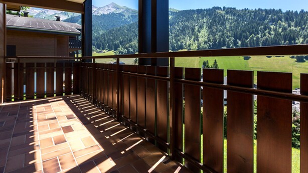 A balcony with a view of a mountainous landscape.