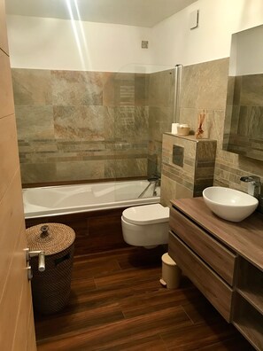 Bathtub, hair dryer, towels, soap