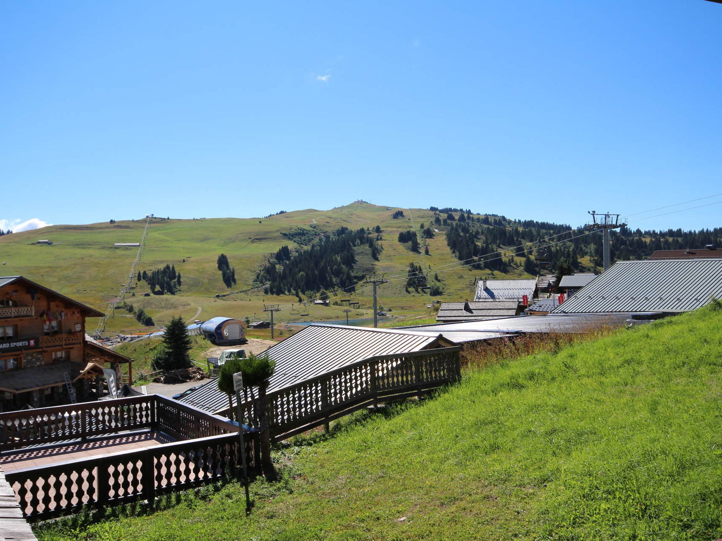 A mountainous landscape with a wooden building labeled 'CARD SPORTS' and a metal-roofed structure.