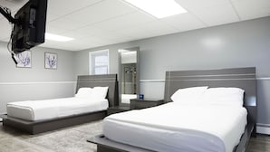 A hotel room with two beds, a television mounted on the wall, and a mirror. - RIVERVIEW VILLA AT OCEAN BEACH: 5 QUEEN BEDS (New London)