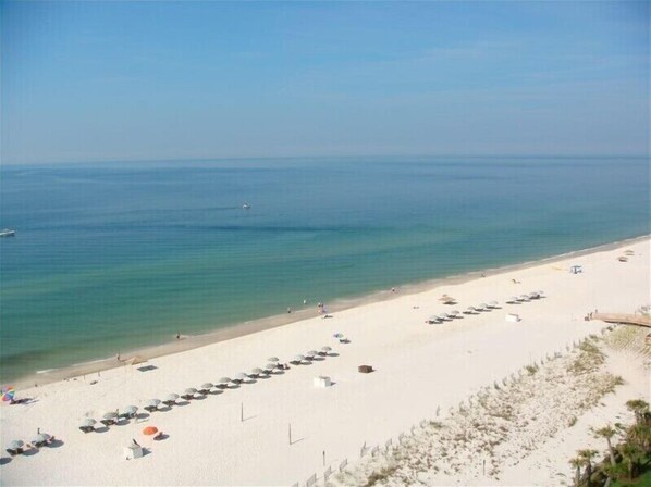 Guests can enjoy a serene beach experience with clear waters and comfortable seating.