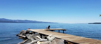 Peaceful home enveloped in a quiet, scenic landscape adjacent to a rocky beach.<br>