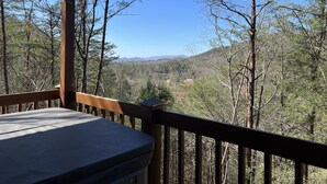 A wooden deck with a view of a forested valley and distant mountains. - *Winter Special* 2 bed 2 bath 10 min PF Private (Sevier County)