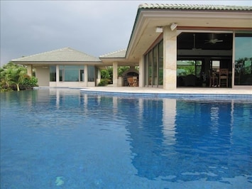 Enjoy dipping in the pool and glass walls that open up on 3 sides of the house.