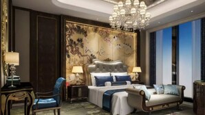 A luxurious bedroom with a large bed, a sofa, a chandelier, and a decorative wall panel. - Wanda Realm Qiqihar (Qiqihar)