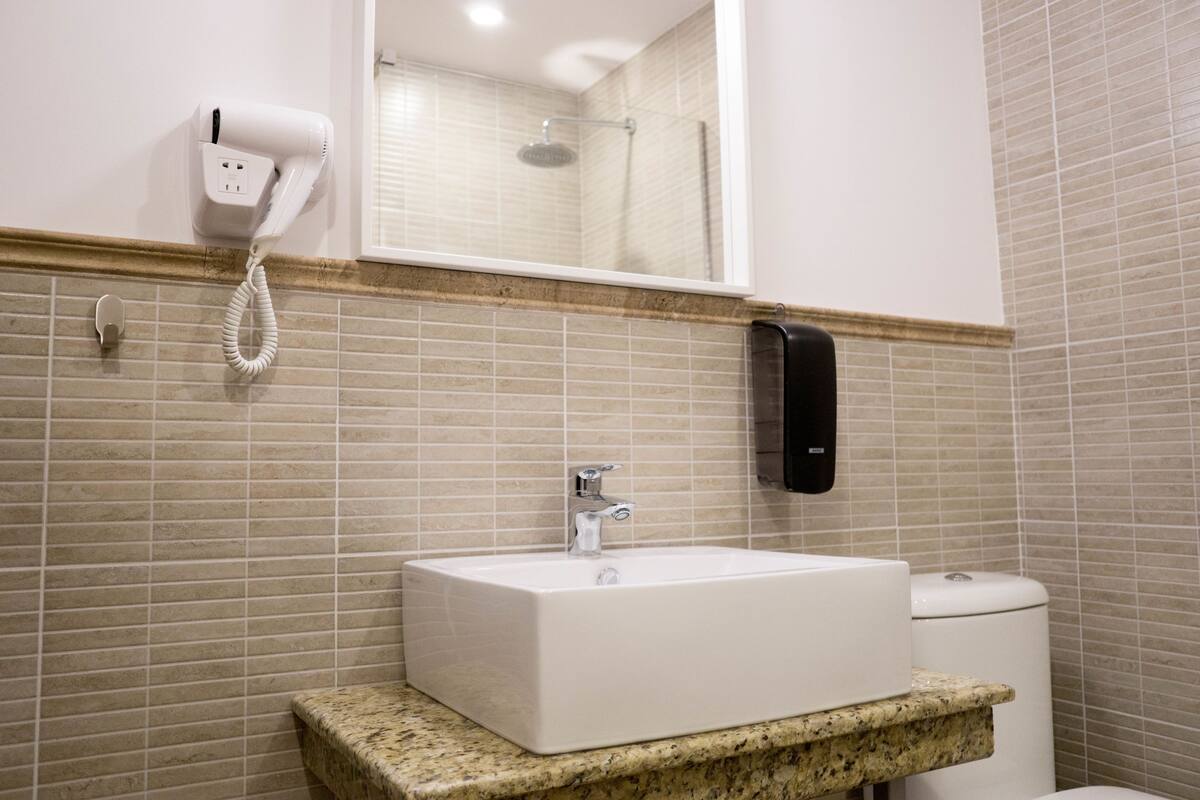 superior studio suite, 1 king bed with sofa bed, garden view | bathroom | shower, rainfall showerhead, free toiletries, hair dryer