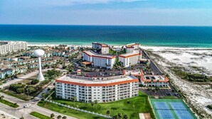 A resort with multiple buildings, a beach, and a tennis court. - El Matador 424 by Alicia Hollis Rentals FREE TICKETS! $300/Day (Fort Walton Beach)