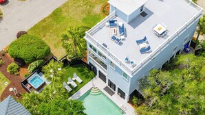 A modern two-story building with a rooftop deck, a swimming pool, and a hot tub. - 3800 Cameron Boulevard| AvantStay | Pool, Ocean Views, Deck (Isle of Palms)