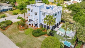 A multi-story building with a pool and outdoor seating area. - 3800 Cameron Boulevard| AvantStay | Pool, Ocean Views, Deck (Isle of Palms)