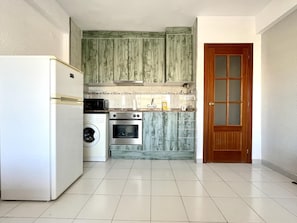 Fridge, microwave, coffee/tea maker, cookware/dishes/utensils