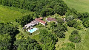 An aerial view of a property with a swimming pool, multiple buildings, and surrounding greenery. - Beautiful Stone Farmhouse With Heated Pool And Views Across Rolling Countryside (Gondrin)