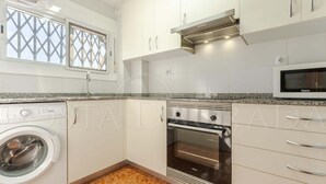 A kitchen with a washing machine, oven, microwave, and cabinets. - 131-POMPEYO II. Apartment located in Cambrils only 300m from the beach (Cambrils)