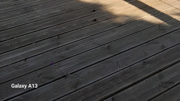 A wooden deck with a table and chairs, overlooking a coastal landscape with trees and a view of the sea. - GROUND FLOOR OF VILLA facing the tip of Giens (Carqueiranne)