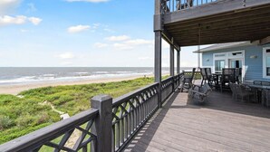 A wooden deck with a view of the beach and ocean. - WOW (Wade on the Water) - Amazing Beachfront with all the extras! (Crystal Beach)