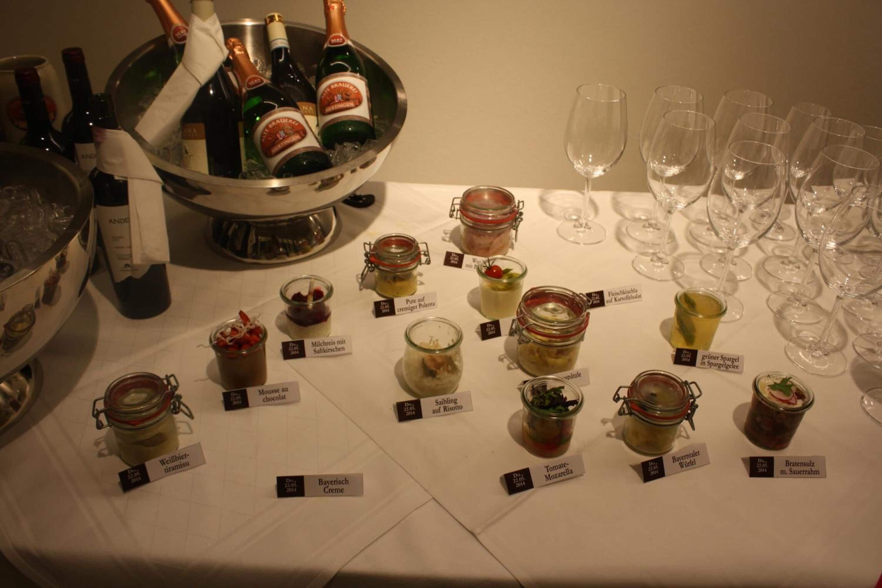 A table with various food items and wine bottles.