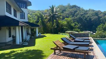 Outdoor pool, an infinity pool, pool loungers