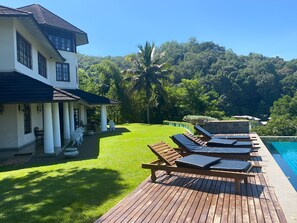 Outdoor pool, an infinity pool, pool loungers