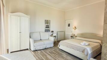 Een hotelkamer met een bed, een slaapbank, een garderobe en een radiator.