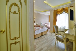 Family Triple Room | Living area | 32-cm LED TV with satellite channels, TV