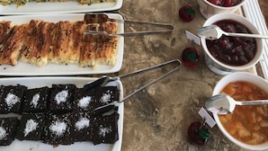 A buffet table with various food items and utensils. - Bozcaada FRESH HOTEL (Bozcaada)