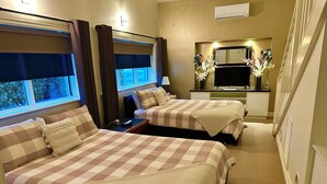A hotel room with two beds, a small kitchenette, a mirror, and a window with curtains. - Austral Place 88 over Merri River (Dennington)