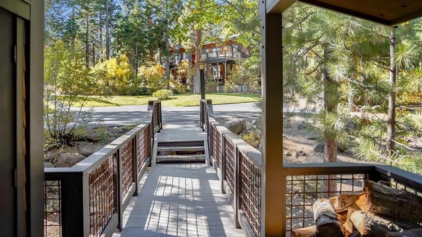 A wooden deck leading to a building surrounded by trees. - Spacious Townhome in the Trees Rocky Ridge Unit #75 (Tahoe City)