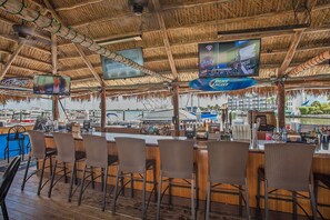 Relax by the marina with a drink in hand at this waterfront bar, offering a variety of options and comfortable seating.
